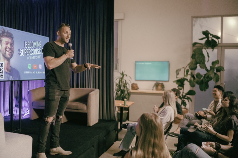 Steven speaking on stage at an event